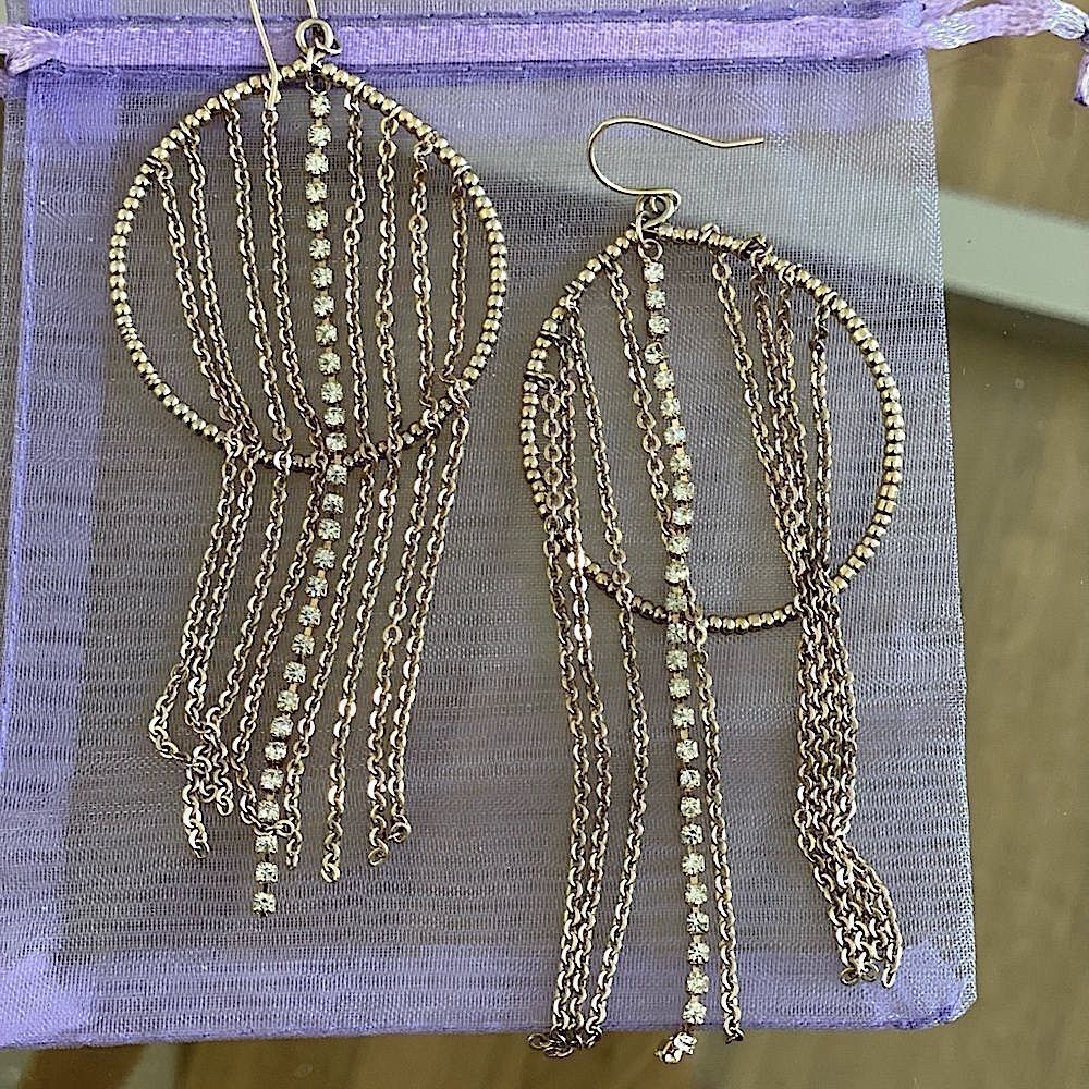 Golden dangle earrings with rhinestone fringe accents